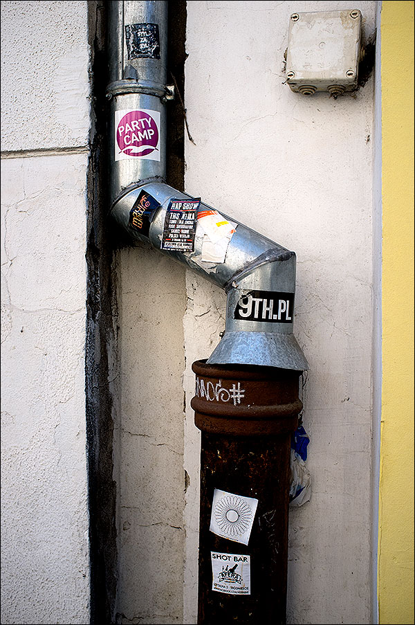 Stickers and grafetti on a drain pipe in Poland 